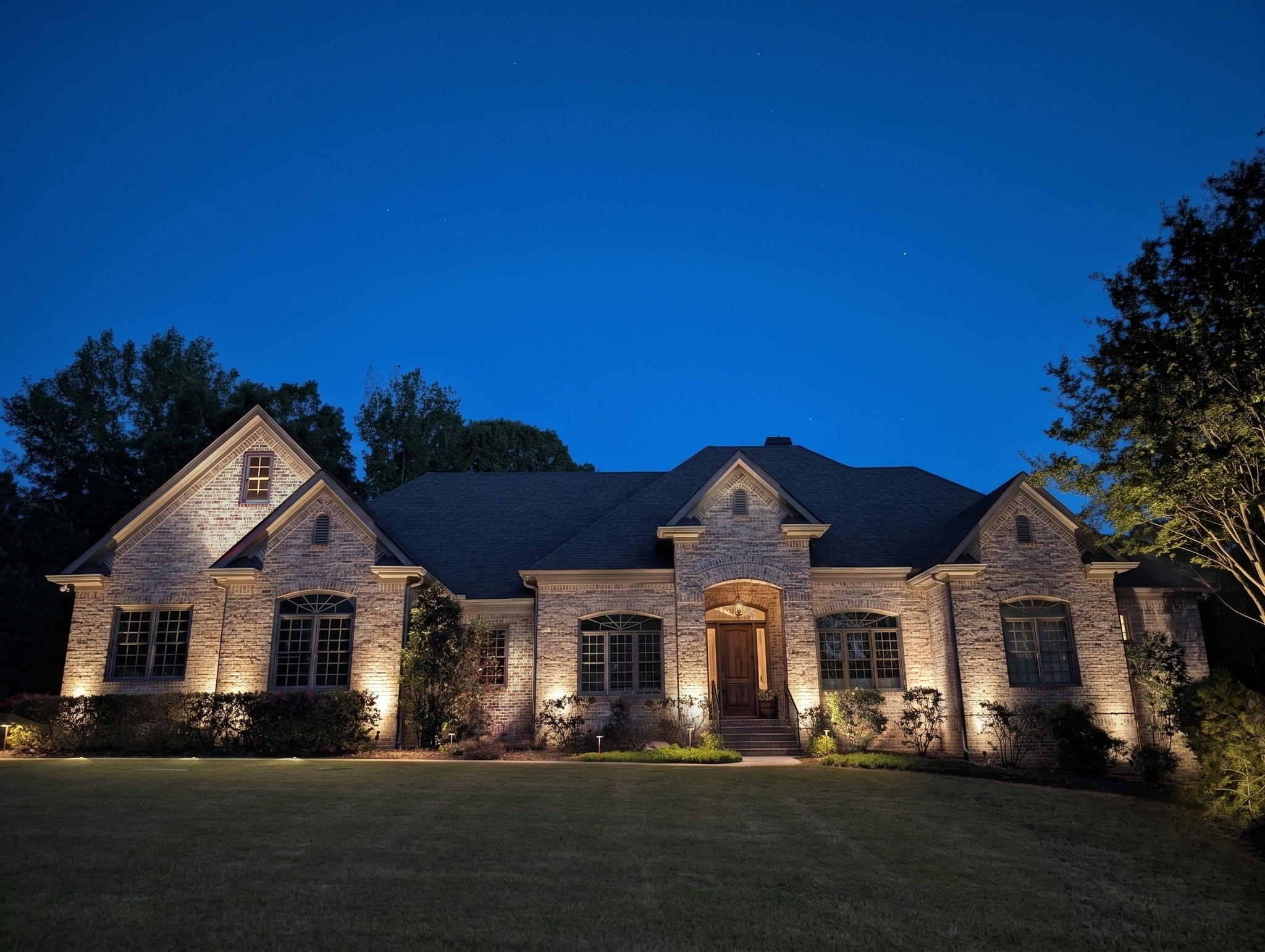 A landscape lighting rendering: a home shown with a recommended lighting design