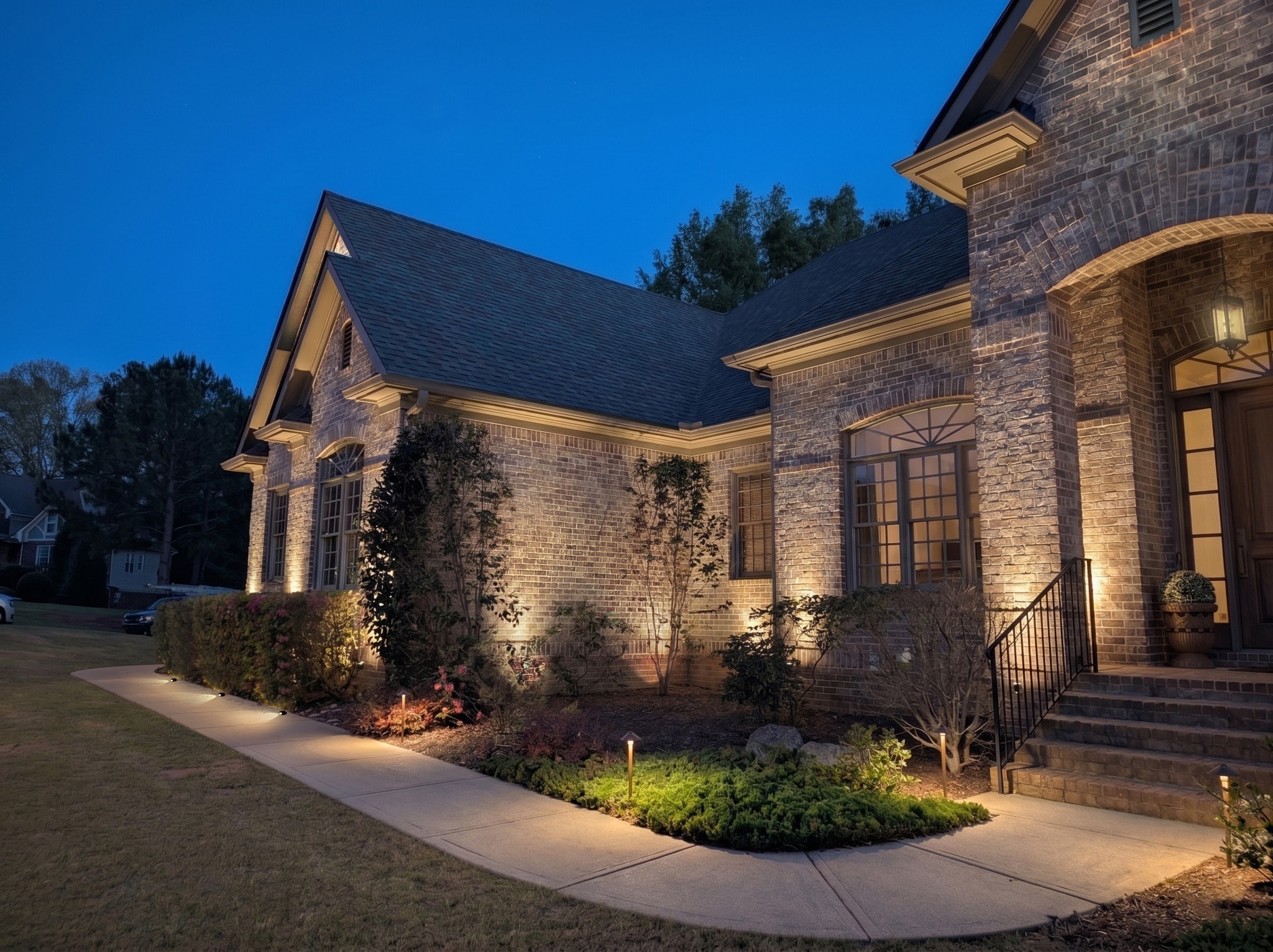 A landscape lighting rendering: a home shown with a recommended lighting design