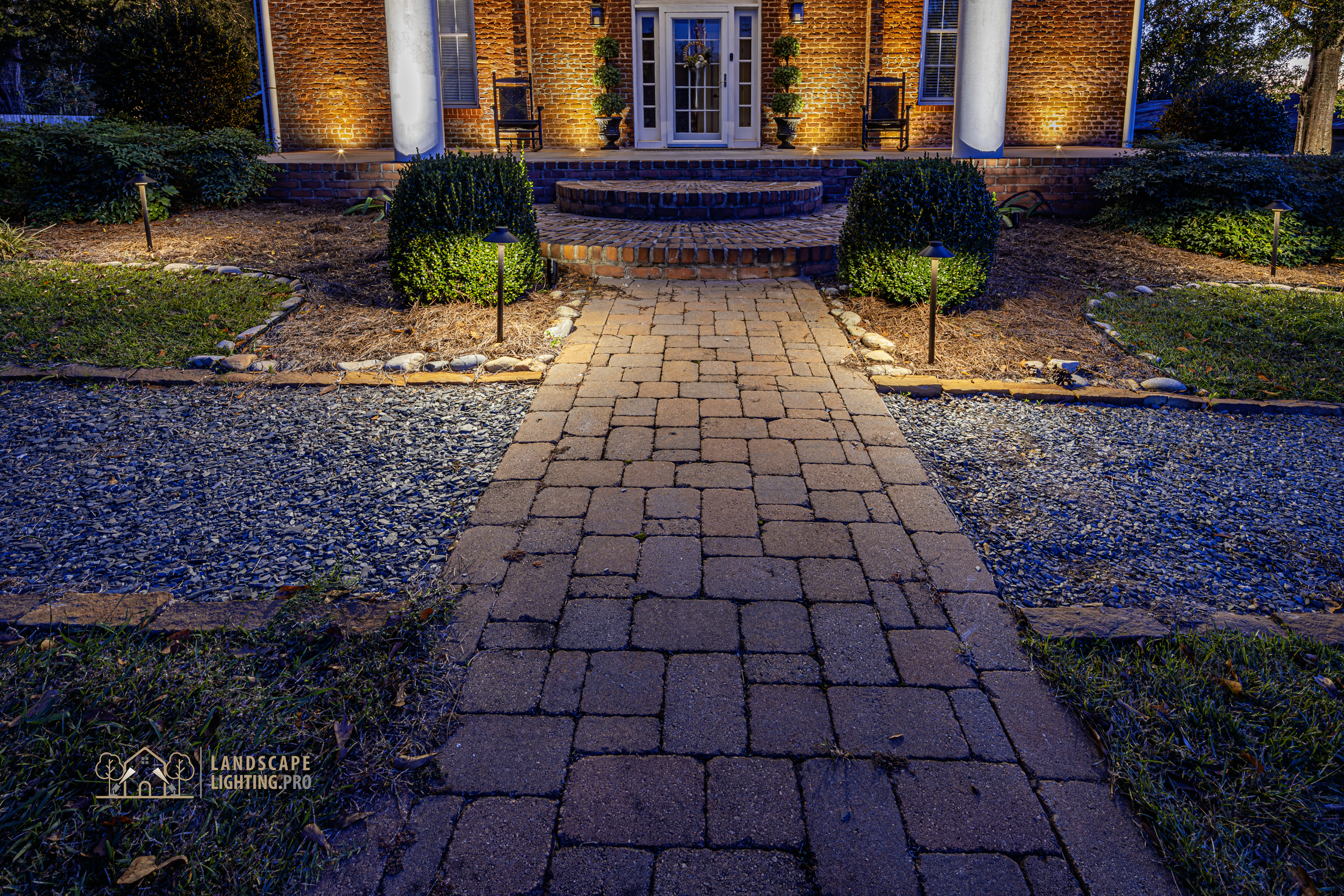 A path-light view along the historic home's entrance walk