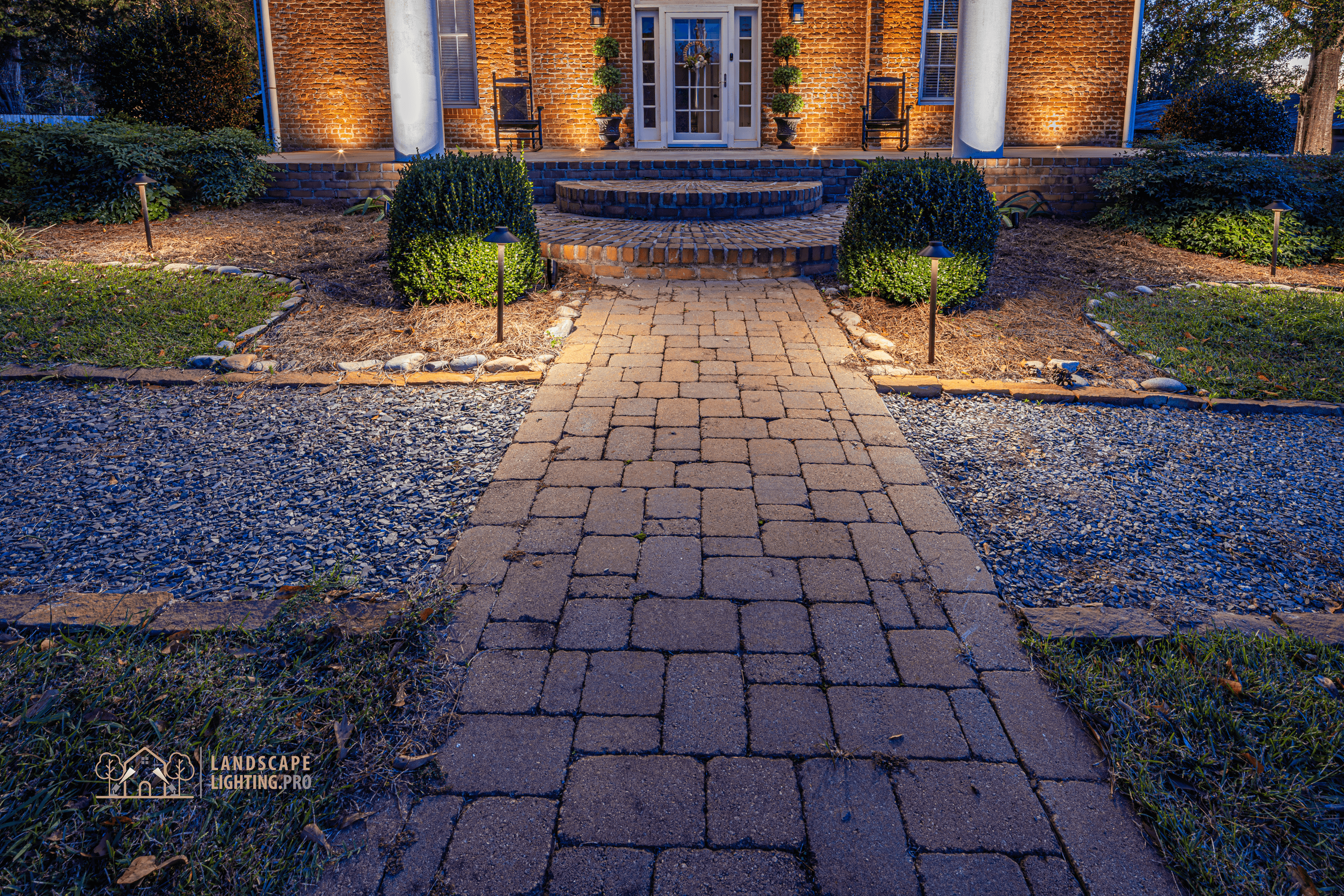 A path-light view along the historic home's entrance walk