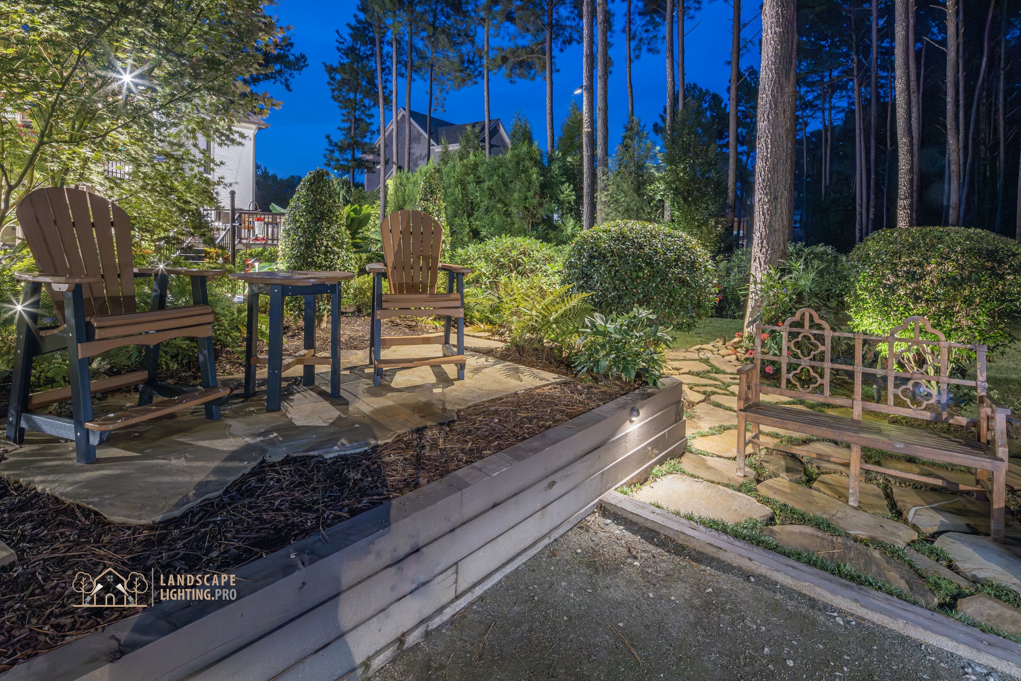 Layered evergreen plantings and lawn lit at dusk on the Newhaven property