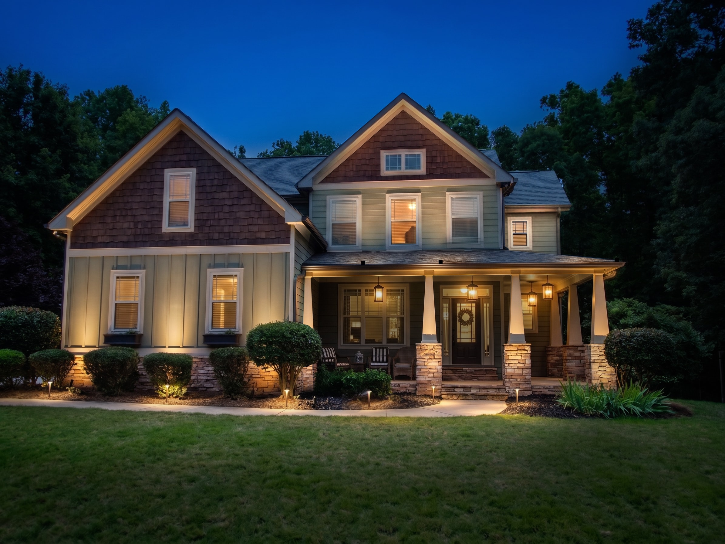 A rendering of the same home with a recommended landscape lighting design shown on it
