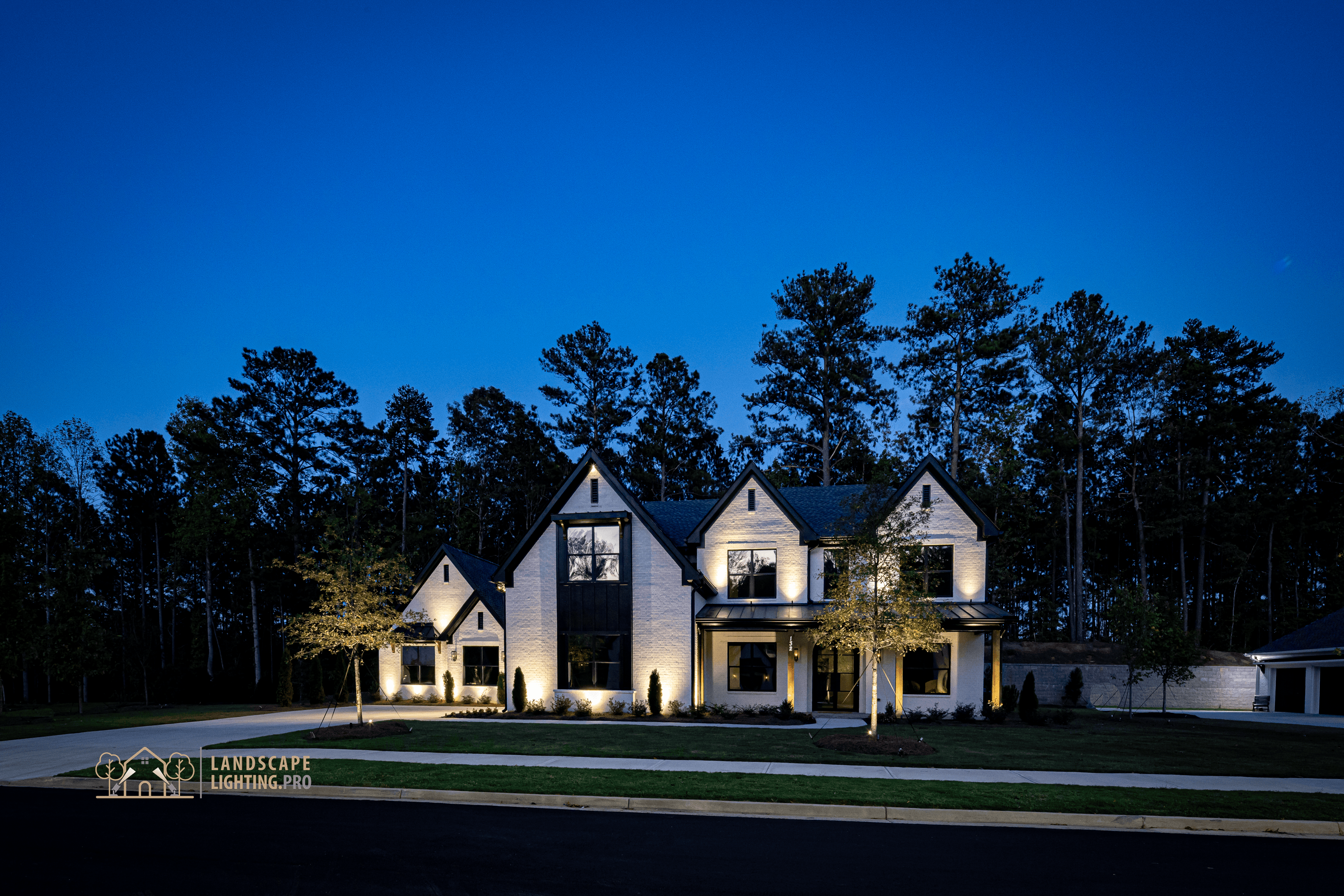 A finished landscape lighting installation at dusk